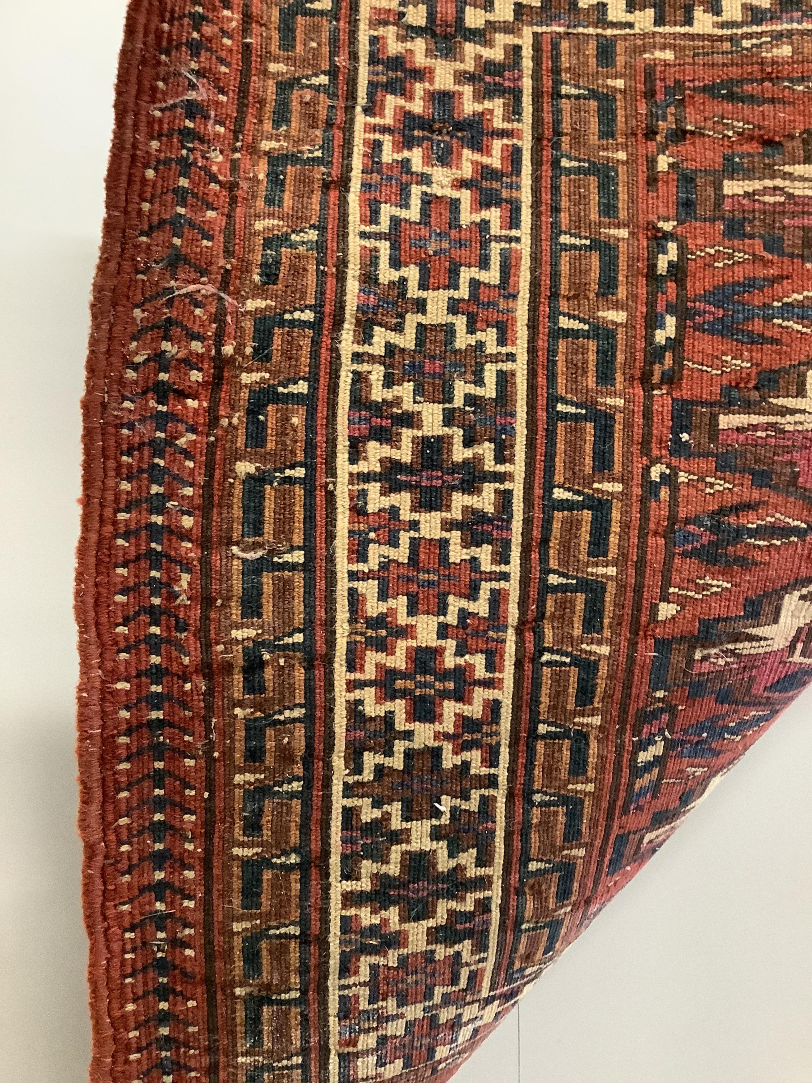 A Bokhara Tekke Turkoman red ground saddle bag rug, 134 x 55cm. Condition - fair